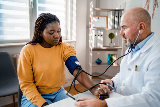 istock Beautiful black woman has her blood pressure checked 1387325067
