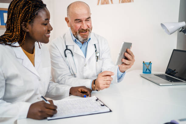 istock Two co-working doctors looking at medical charts on digital tablet 1387325110