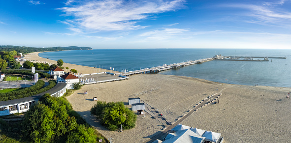 Holidays in Poland - a beach with a view of the pier in the morning in Sopot, a health resort on the Baltic Sea. The pier is the longest wooden pier in Europe