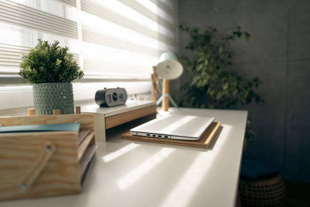 Office supplies and laptop on the desk at the small home office