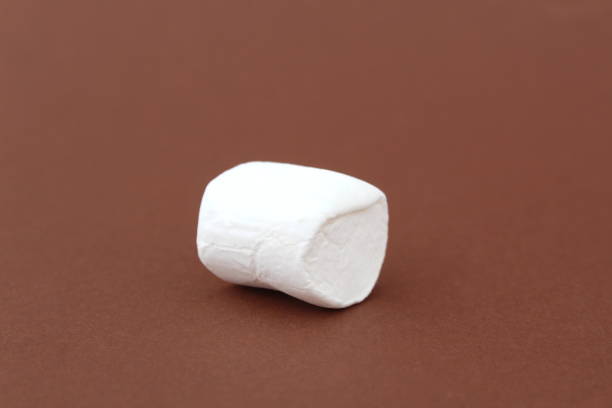 istock One large marshmallow lies on a brown background. 1387328172