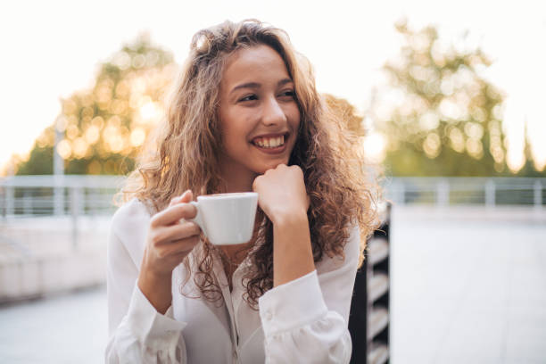 istock woman enjoying cappuccino in a cafe 1387329223