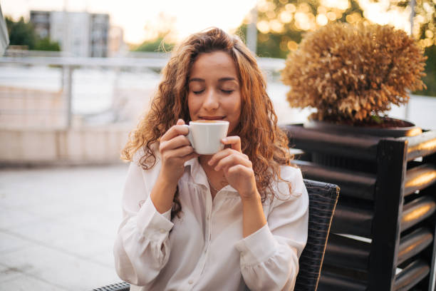 istock woman enjoying cappuccino in a cafe 1387329228