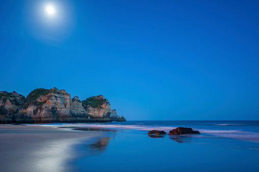 Praia dos Tres Irmaos, rocky landscape on the beach of Alvor in the Algarve in Portugal