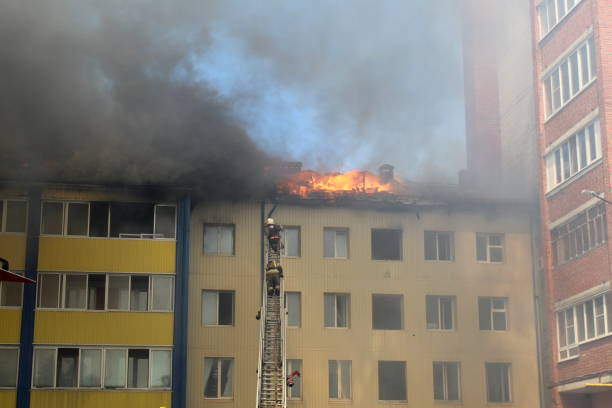 istock Firefighters climb the fire escape to put out the fire. 1387330588
