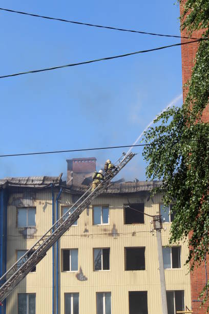 istock Firefighters climb the fire escape to put out the fire. 1387330847