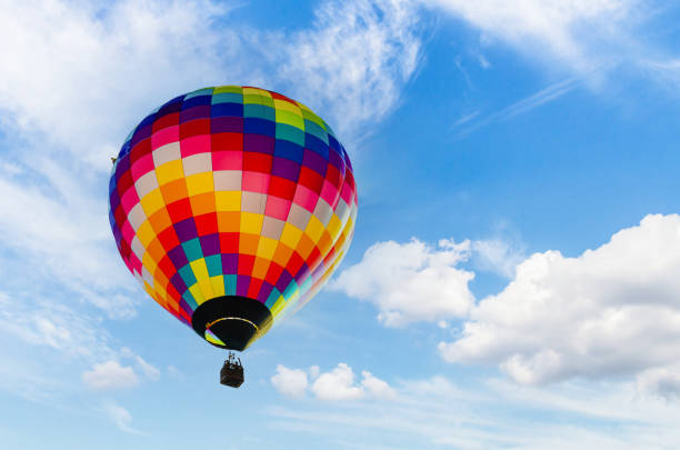 istock Hot air balloon flight over blue sky 1387330974