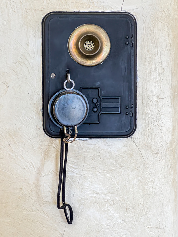 Vintage electrical intercom station on wall of historic estate in Florida, primarily for owners to summon domestic staff on duty elsewhere on the premises