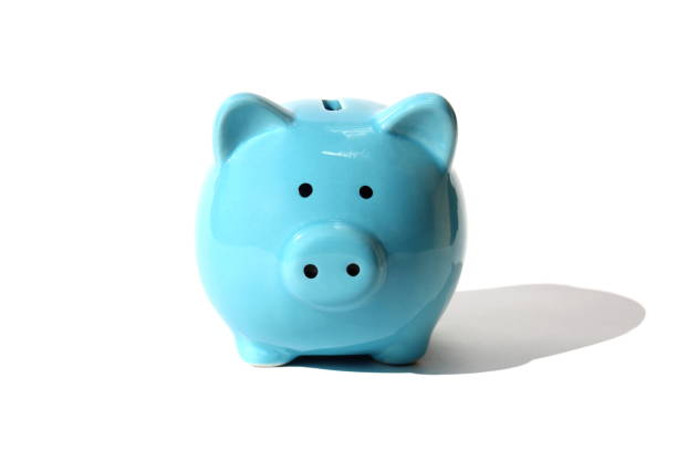 a blue piggy bank stands on a white background.