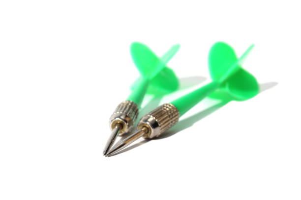 istock Two green darts for darts lie on a white background. 1387333621