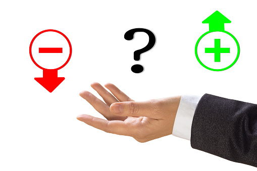 Choice concept. Human hand with open palm in sleeve of a business suit and question mark between heart sign and symbol of money, isolated on white. Honesty, hesitation, decision, profit, conscience, love, calculation