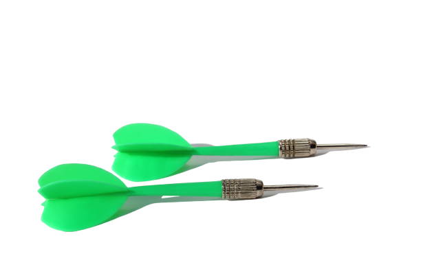istock Two green darts for darts lie on a white background. 1387333785