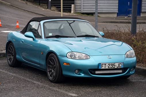 Mulhouse - France - 12 March 2022 - Front view of blue Mazda MX5 convertible parked in the street
