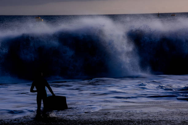 istock Surfer at sunset on a calm ocean 1387339246