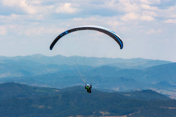 istock paragliding above the mountain valley 1387344178