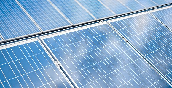 Grouping of photovoltaic solar panels on rooftop of a solar power plant.
