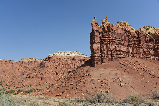A beautifully colorful panoramic landscape of eroded sandstone formations, mesas, cliffs and mountains in Northern New Mexico. Note the full frame format.