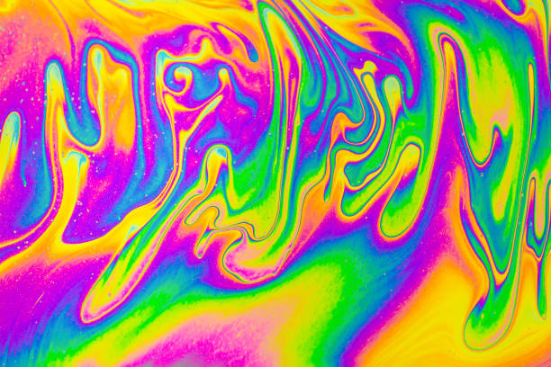 istock Rainbow colors. Psychedelic multi colored patterns background. Photo macro shot of soap bubbles 1387350771