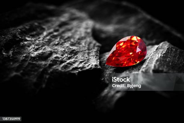 Red Ruby Gemstone Round Cut On Stone Background Close Up Shot Stock Photo - Download Image Now