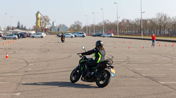 Motorcyclist improving her driving skills at a motorcycle training stock photo