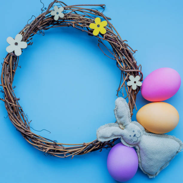 istock Happy Easter concept. Holiday preparation. Easter eggs and bunny isolated on trendy pastel blue background. simple minimalism flat lay top view copy space 1387351716