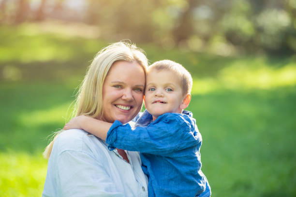 Portrait of Mother and son outdoors in the sunshine. Portrait of Mother and son outdoors in the sunshine. Both are happy and smiling. cleft lip stock pictures, royalty-free photos & images