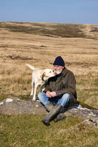 istock Old man and his dog in the hills 1387352791