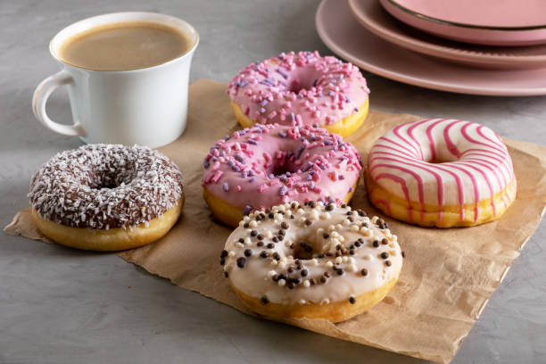 istock Several donuts lie on craft parchment paper on gray surface 1387352819