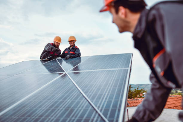 istock Senior Worker Checking Younger Colleagues Measuring Solar Panel Diagonally On House Roof 1387355423