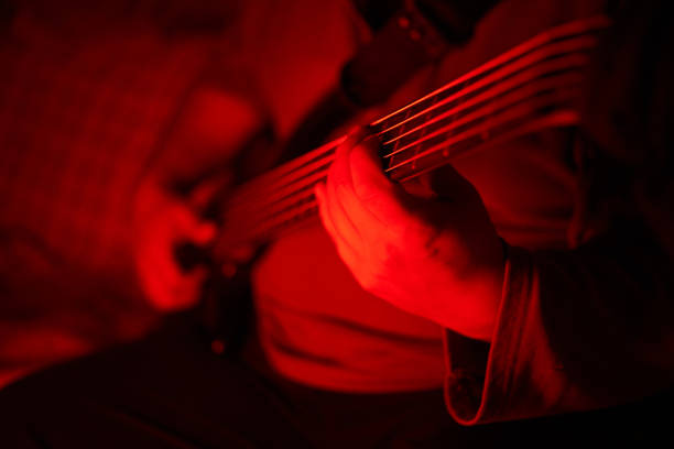A man exercising with bass guitar at home