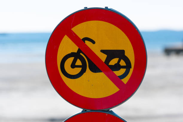 istock Moped prohibited sign by a beach.. 1387358382
