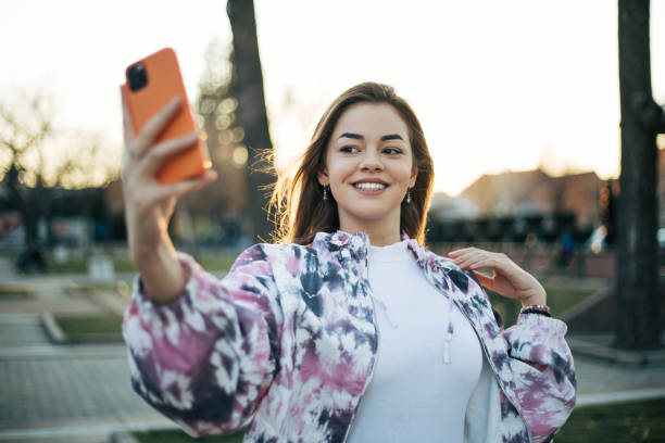istock Beautiful young woman taking selfie 1387358727