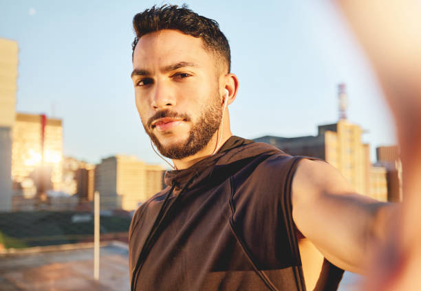 Shot of a young man taking a selfie while out for a workout