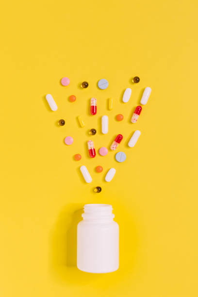 istock Pills laid out in heart shape near jar 1387359716