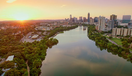 Aerial View of Colorado river passing through tree covered downtown Austin, Texas, USA.