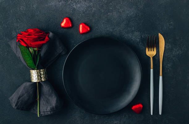 istock Festive table setting for Valentine's Day with cutlery, rose and chocolate hearts. Flat lay 1387368205