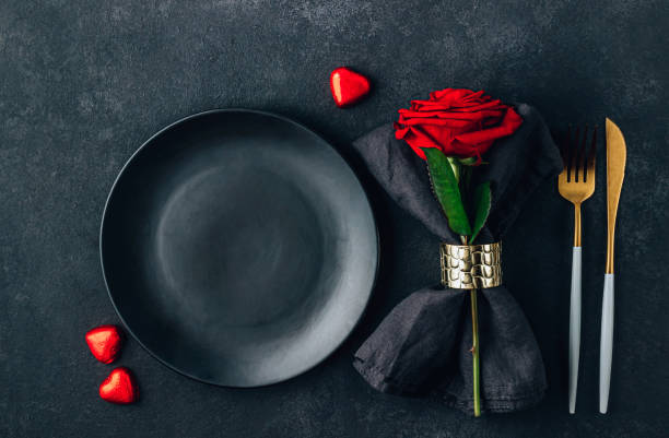 istock Festive table setting for Valentine's Day with cutlery, rose and chocolate hearts. Flat lay 1387368220