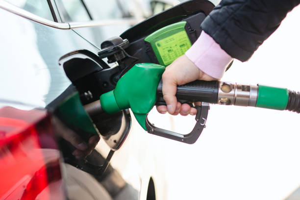 istock Man Pumping Gasoline Into the Car 1387369070