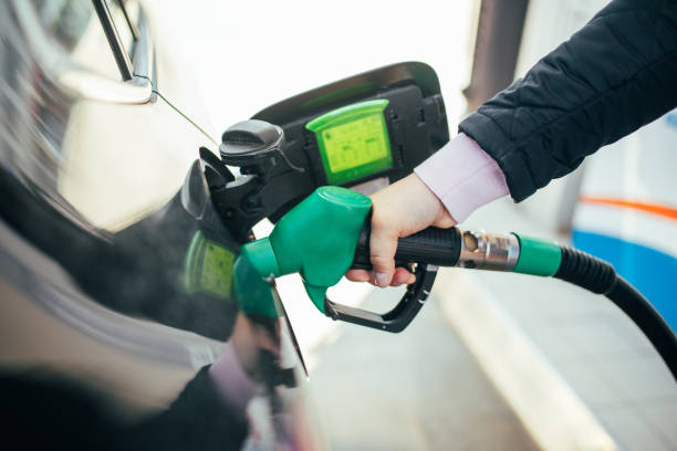 istock Man Pumping Gasoline Into the Car 1387369073