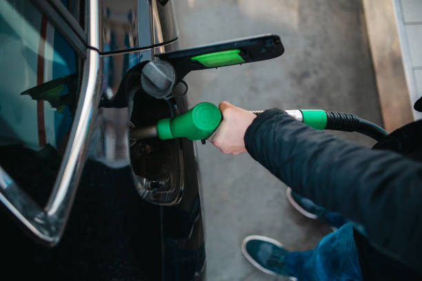 Car is filled with petrol at a filling station
