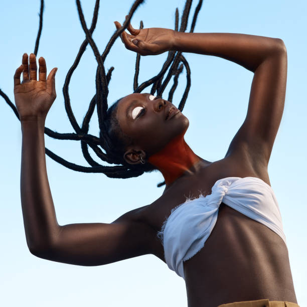 shot of a beautiful young traditional woman posing outside - african dance imagens e fotografias de stock