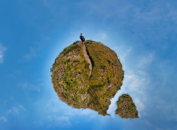 istock tiny planet person hiking on green planet 1387372770