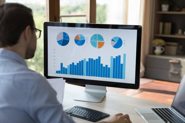 istock Rear view concentrated millennial businessman analyzing statistics. 1387372792