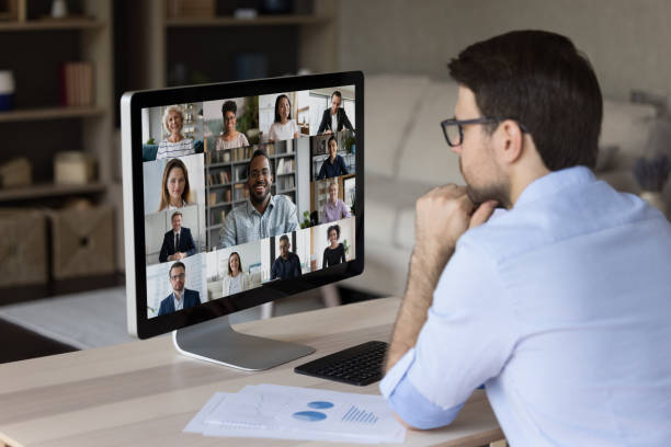 istock Focused young businessman holding video conference call. 1387372798