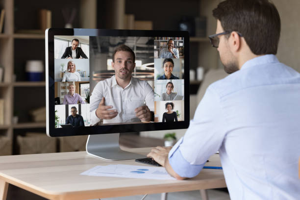 concentrated young businessman involved in video call meeting. - social housing audio imagens e fotografias de stock