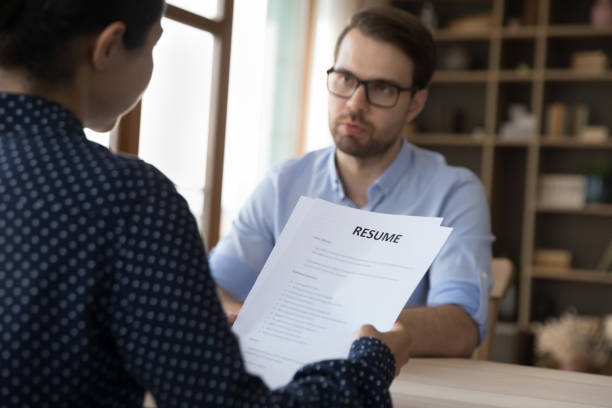 istock Concentrated young Indian hr manager holding job interview with candidate. 1387372807
