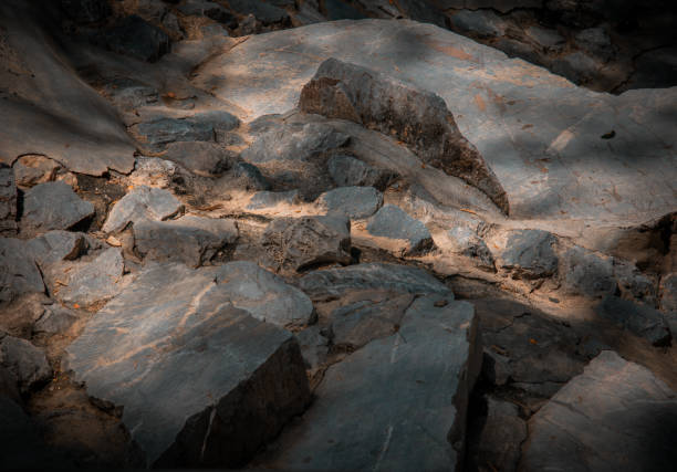 Sunbeams lighting down of stone slab at brookside. Abstract background texture, Beautiful background for wallpaper, Copy space, No focus, specifically.