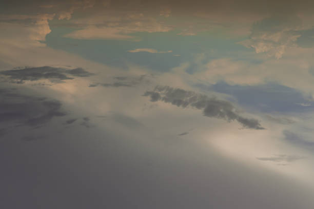 istock The sun shines through the clouds in the evening sky with dramatic light. 1387376338