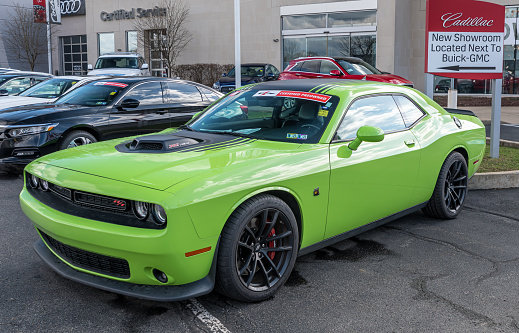Monroeville, Pennsylvania, USA March 20, 2022 A 2019 lime green Dodge Charger with a 392 Hemi motor for sale at a dealership on a sunny spring day
