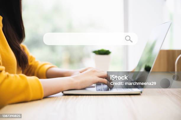 Woman Using Computer Laptop On Wood Desk She Working At Home Stock Photo - Download Image Now